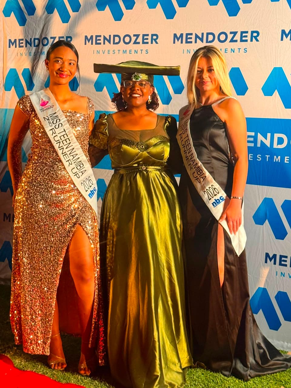 Guests at a Mendozer-branded community event backdrop