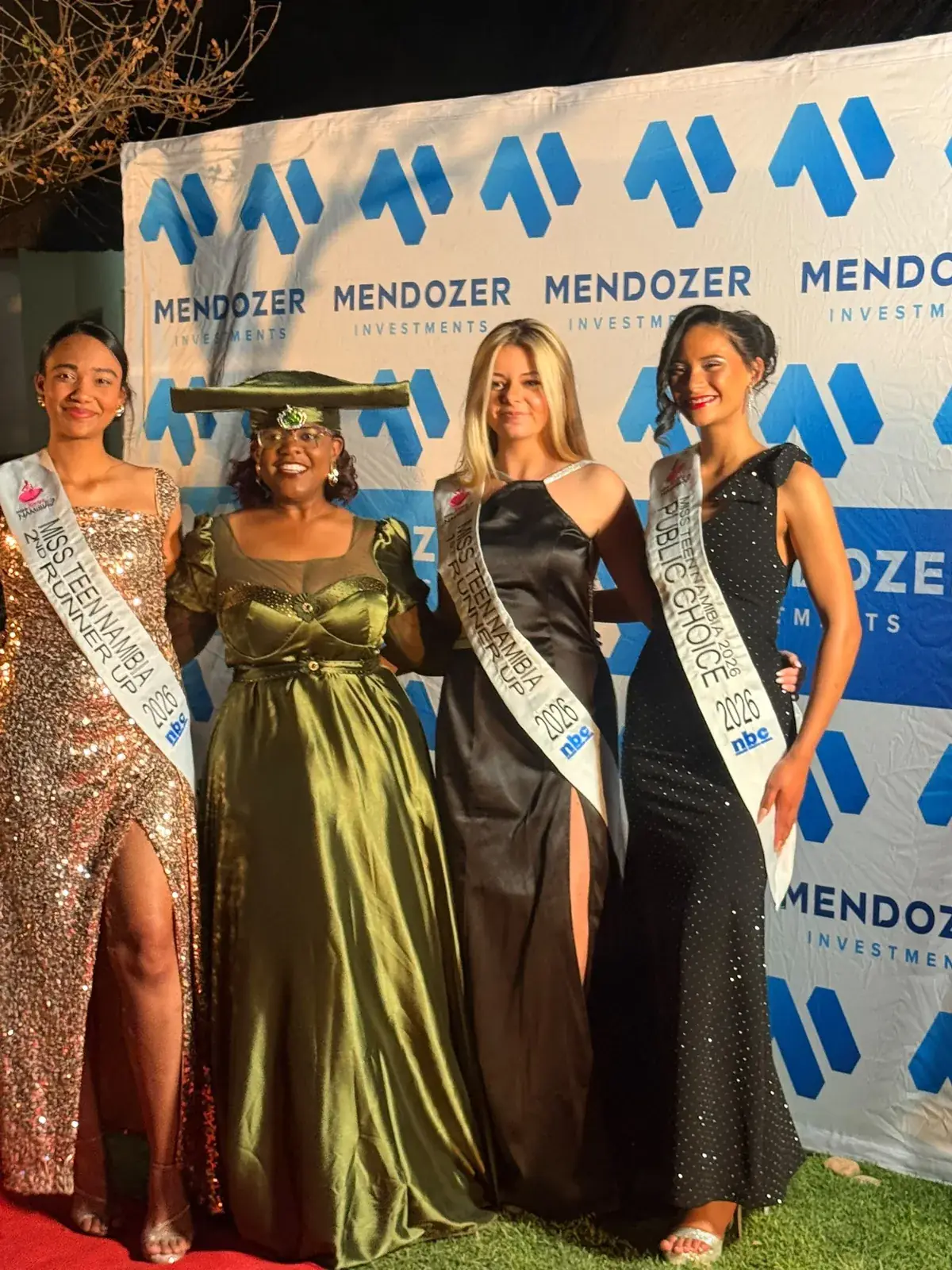 Miss Teen Namibia 2026 titleholders with a guest at the event backdrop