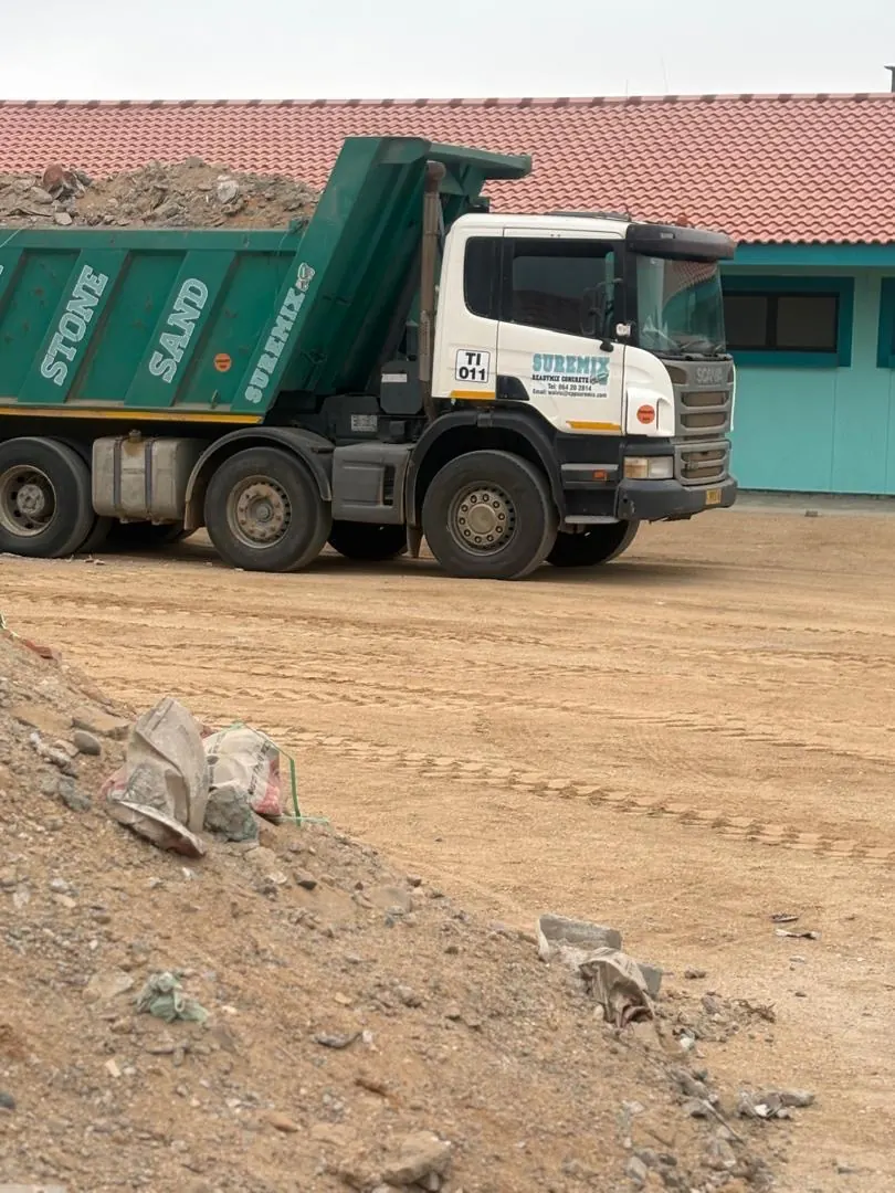 Tipper truck delivering fill material at the Henties Bay school site