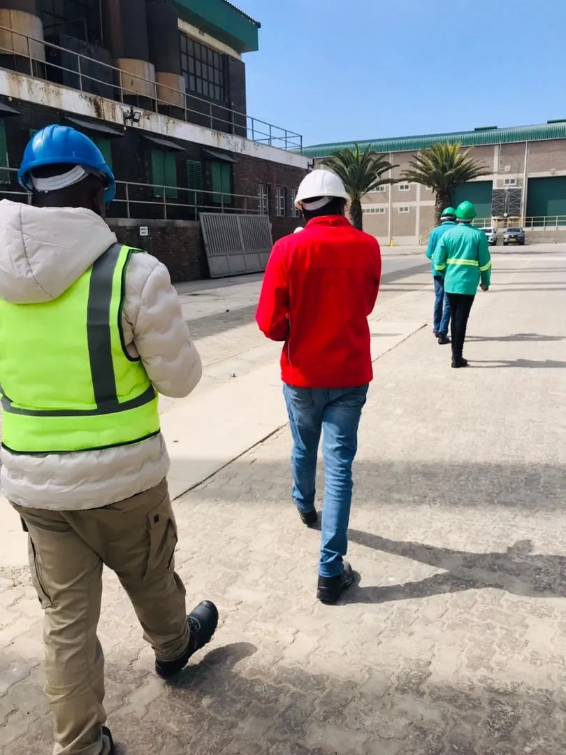 Crew walking between facility buildings on a clear day