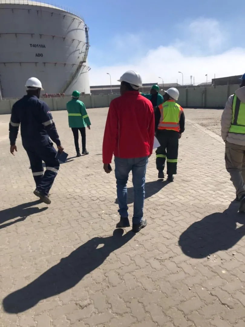 Team walking across a tank storage facility