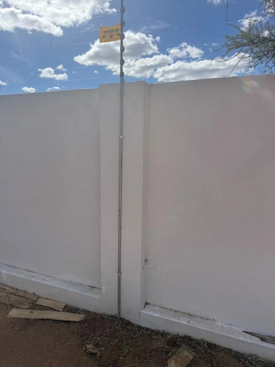 Corner post with electric fence brackets and wiring