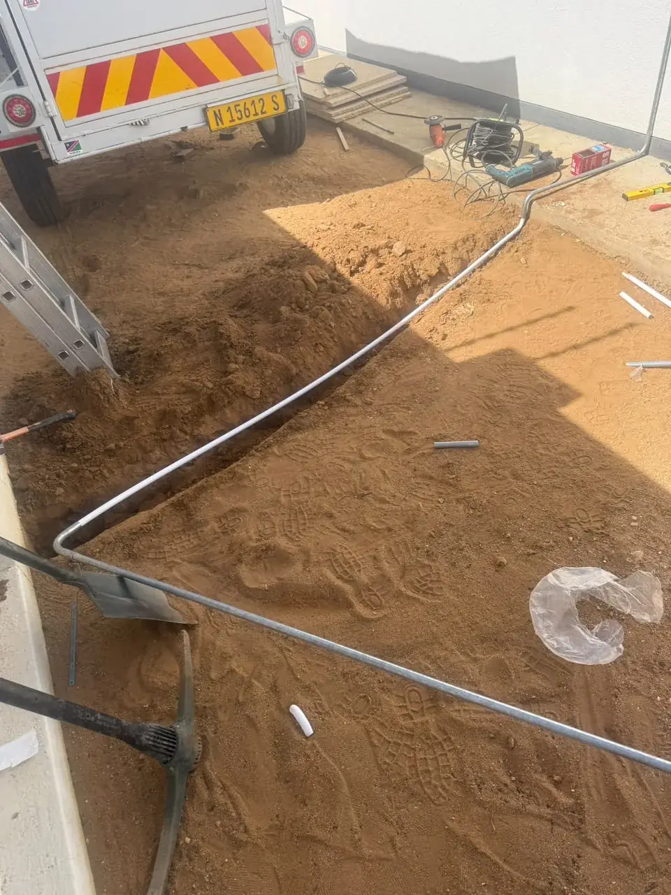 Long run of electric fence wire along a boundary wall