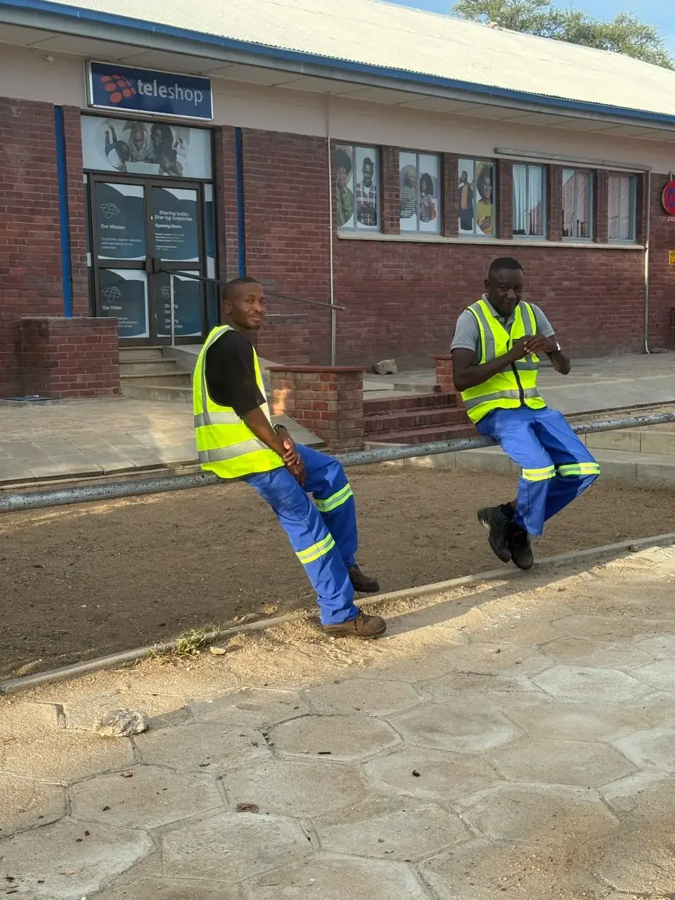 Mendozer crew members in branded high-visibility site wear, third view