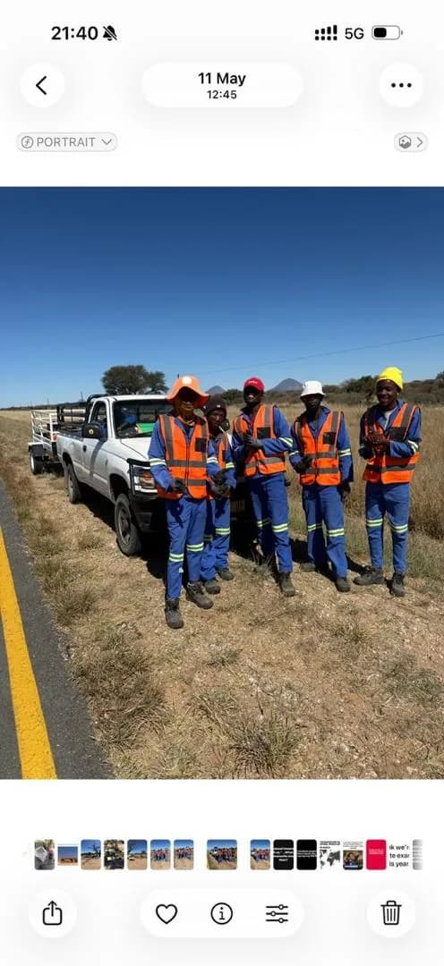 Mendozer work crew gathered beside a road