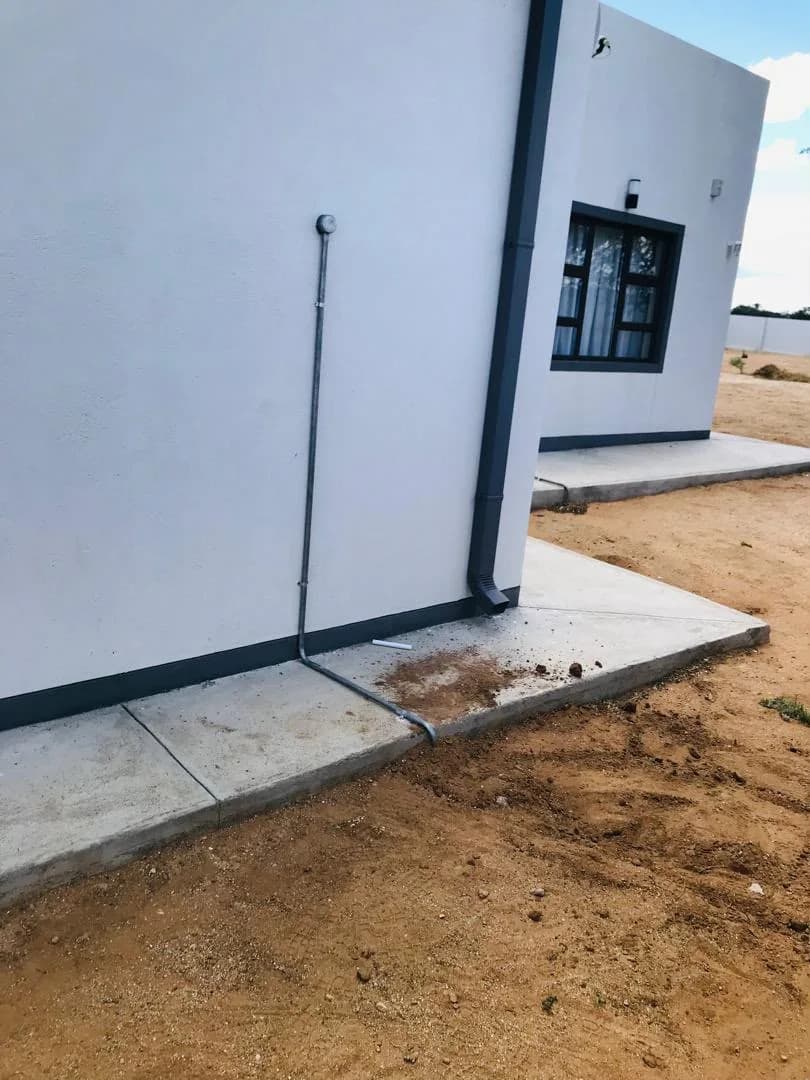 Downpipe and plumbing detail on a house exterior